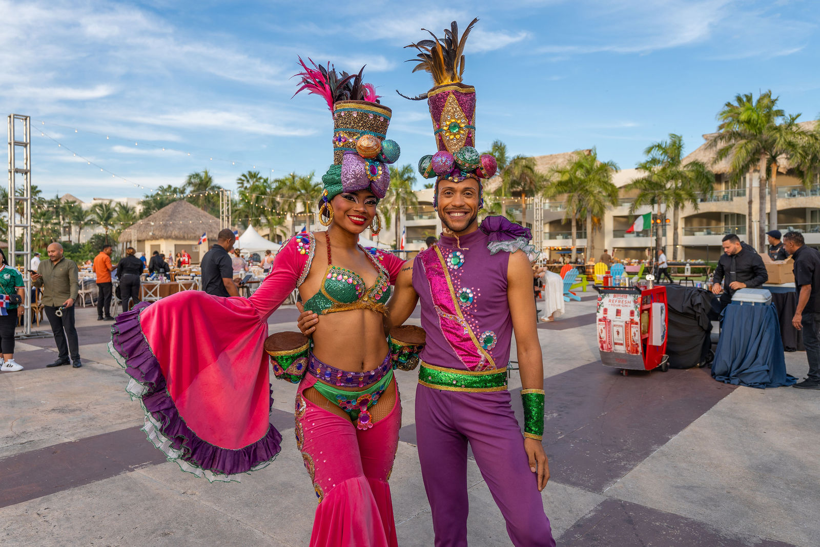 Carnival performers in feathered magenta costumes