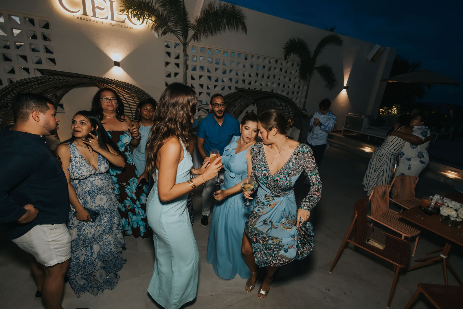 Guests dancing beneath the illuminated venue signage