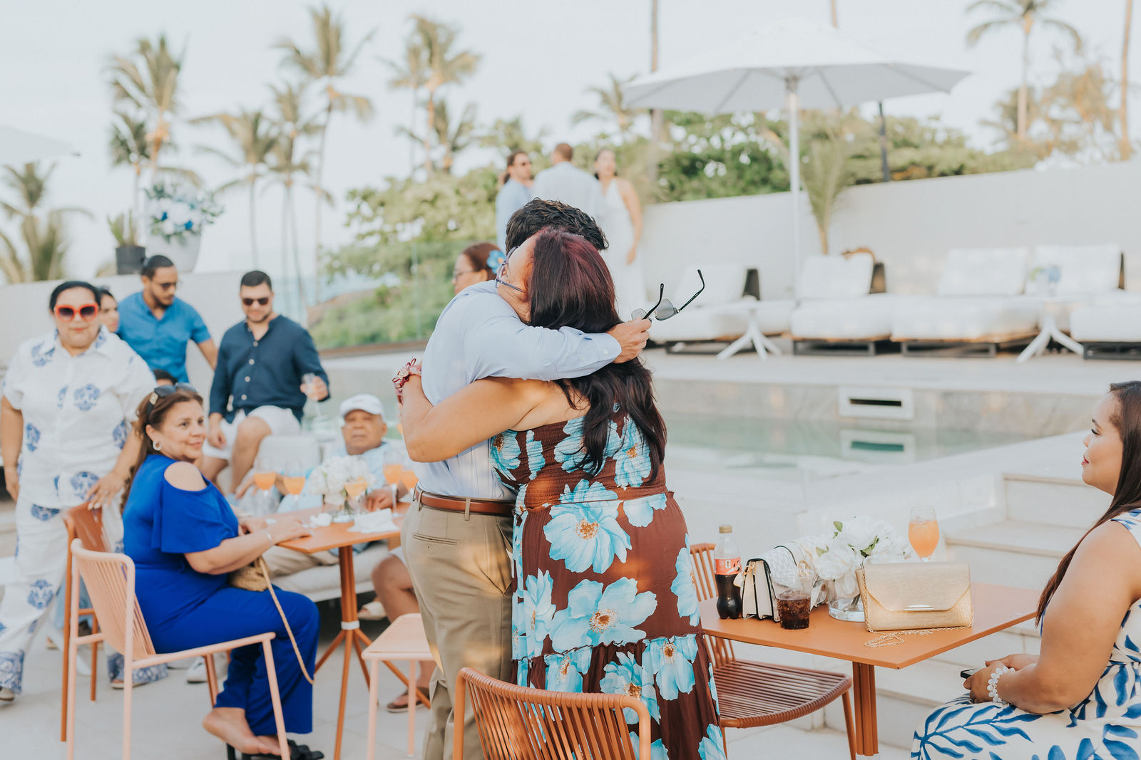 Guests hugging as they greet each other at the party