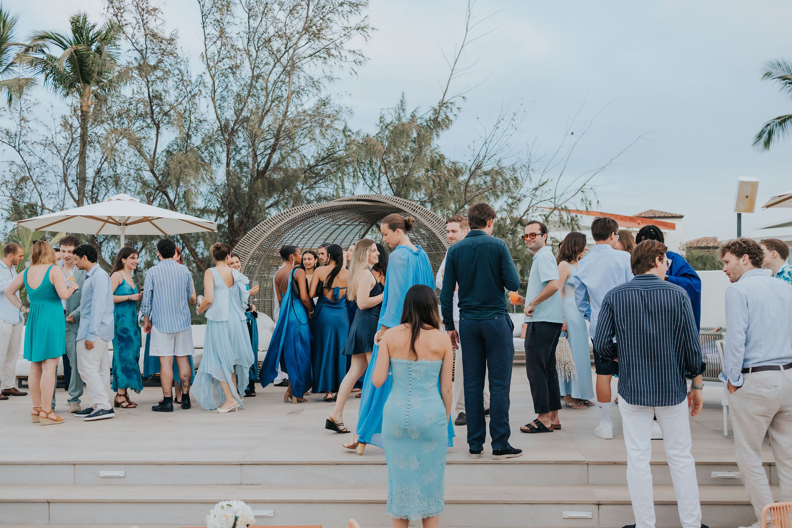 Wide frame of the terrace celebration with the ocean beyond
