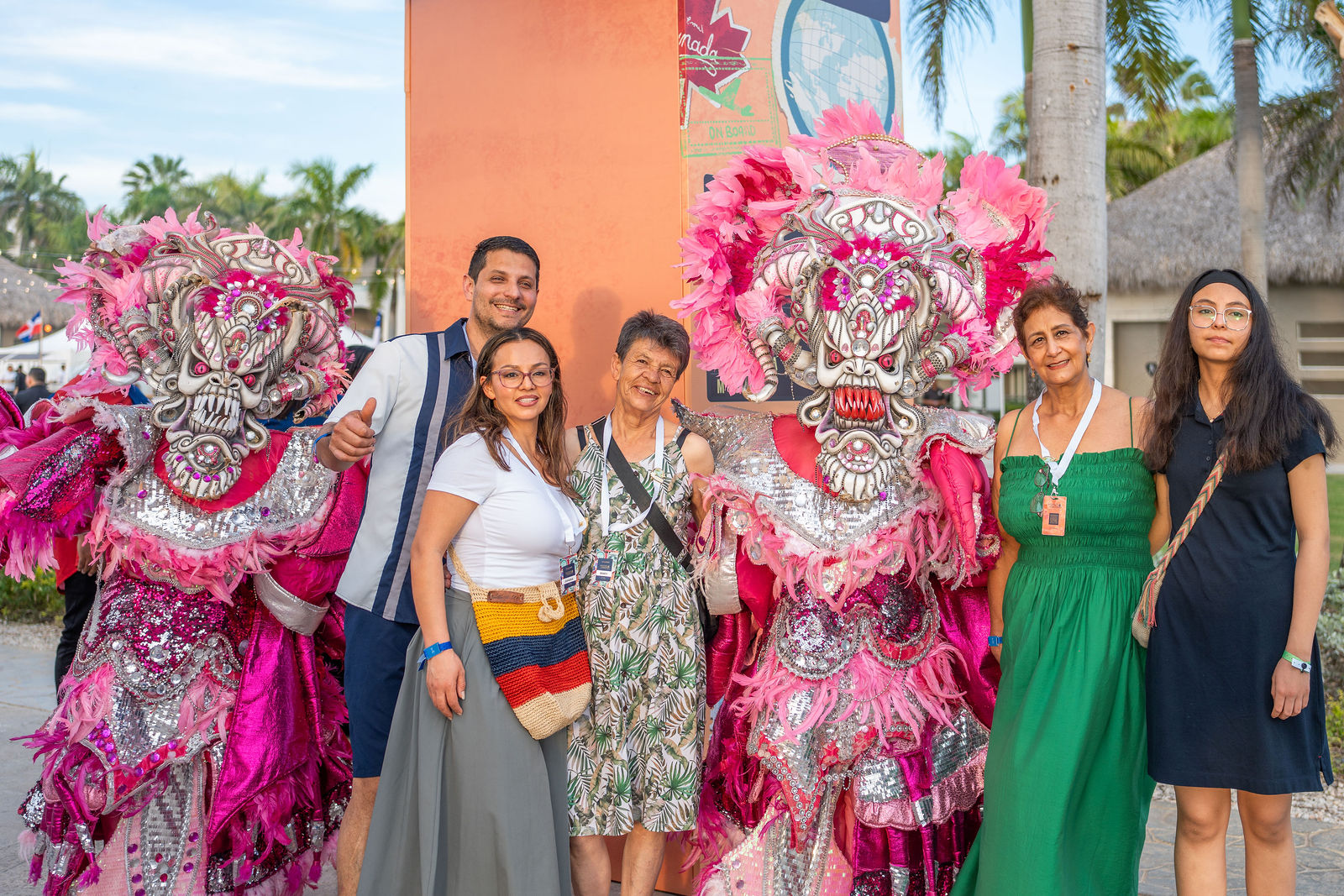 Delegates posing with elaborate Dominican carnival costumes