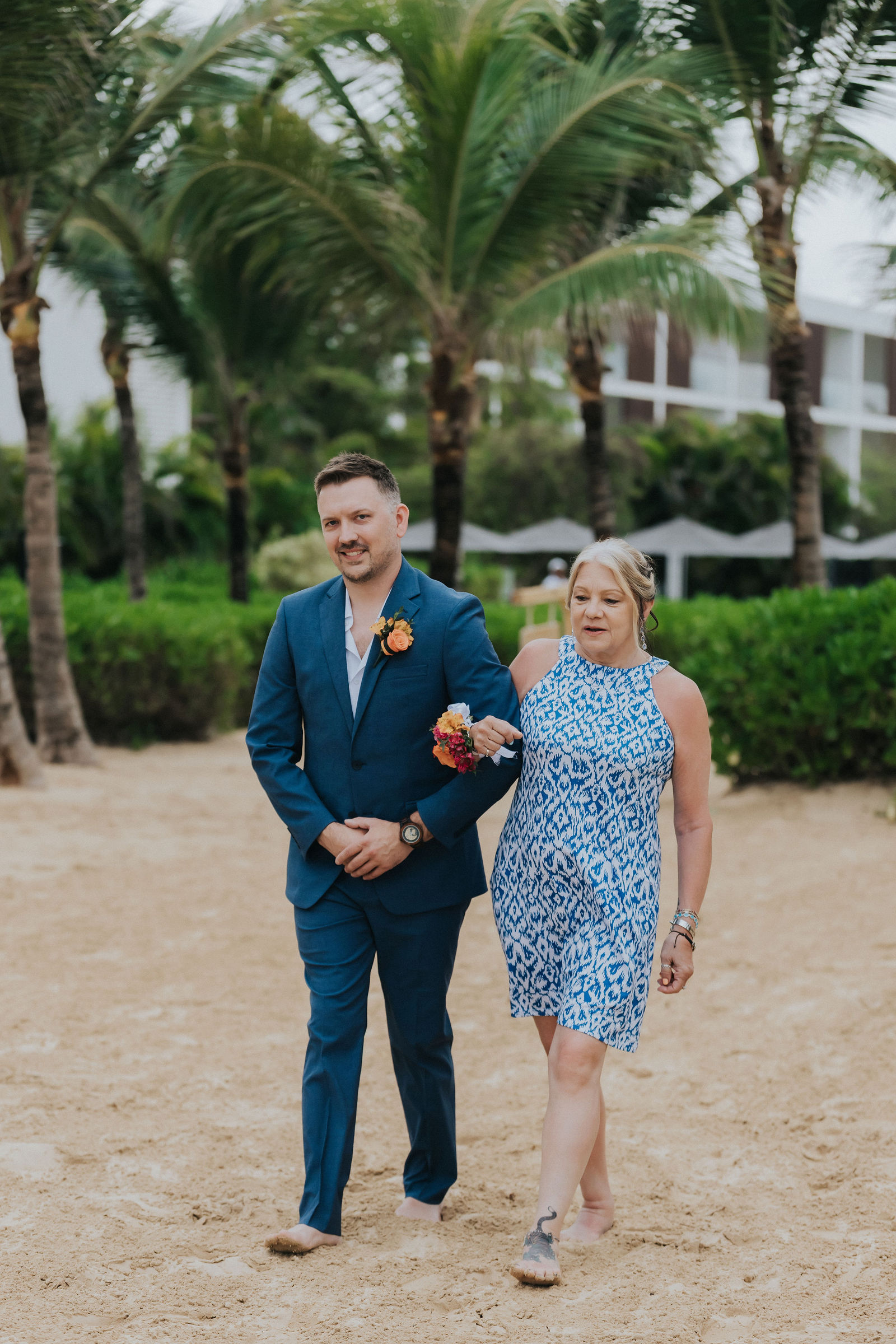 Groom waiting among the palms before the first look