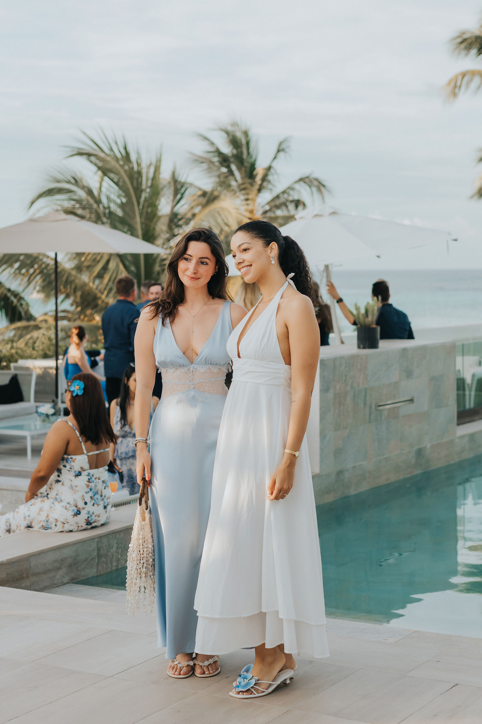 Portrait of two guests by the infinity pool at golden hour
