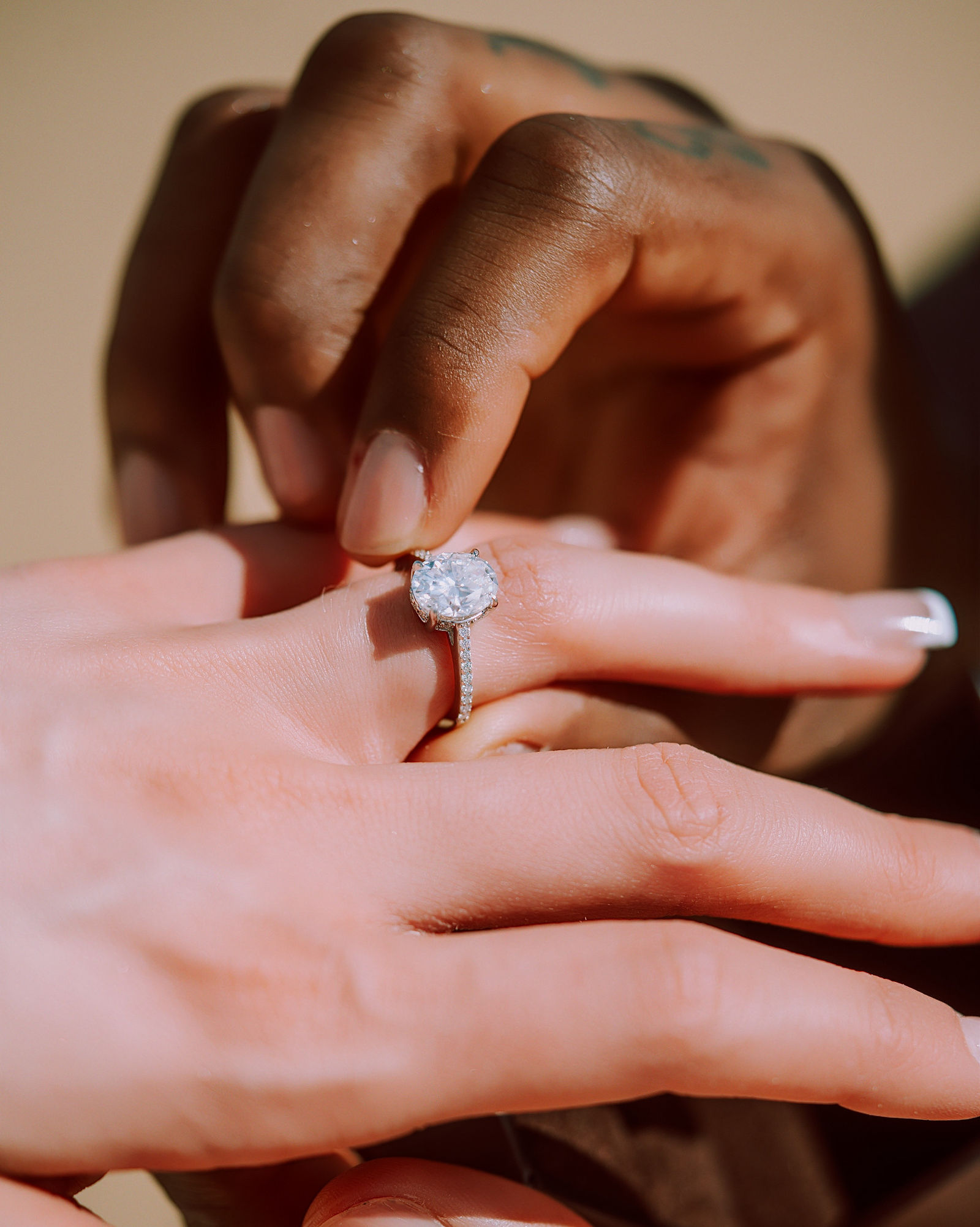 Close-up of the engagement ring in the sand