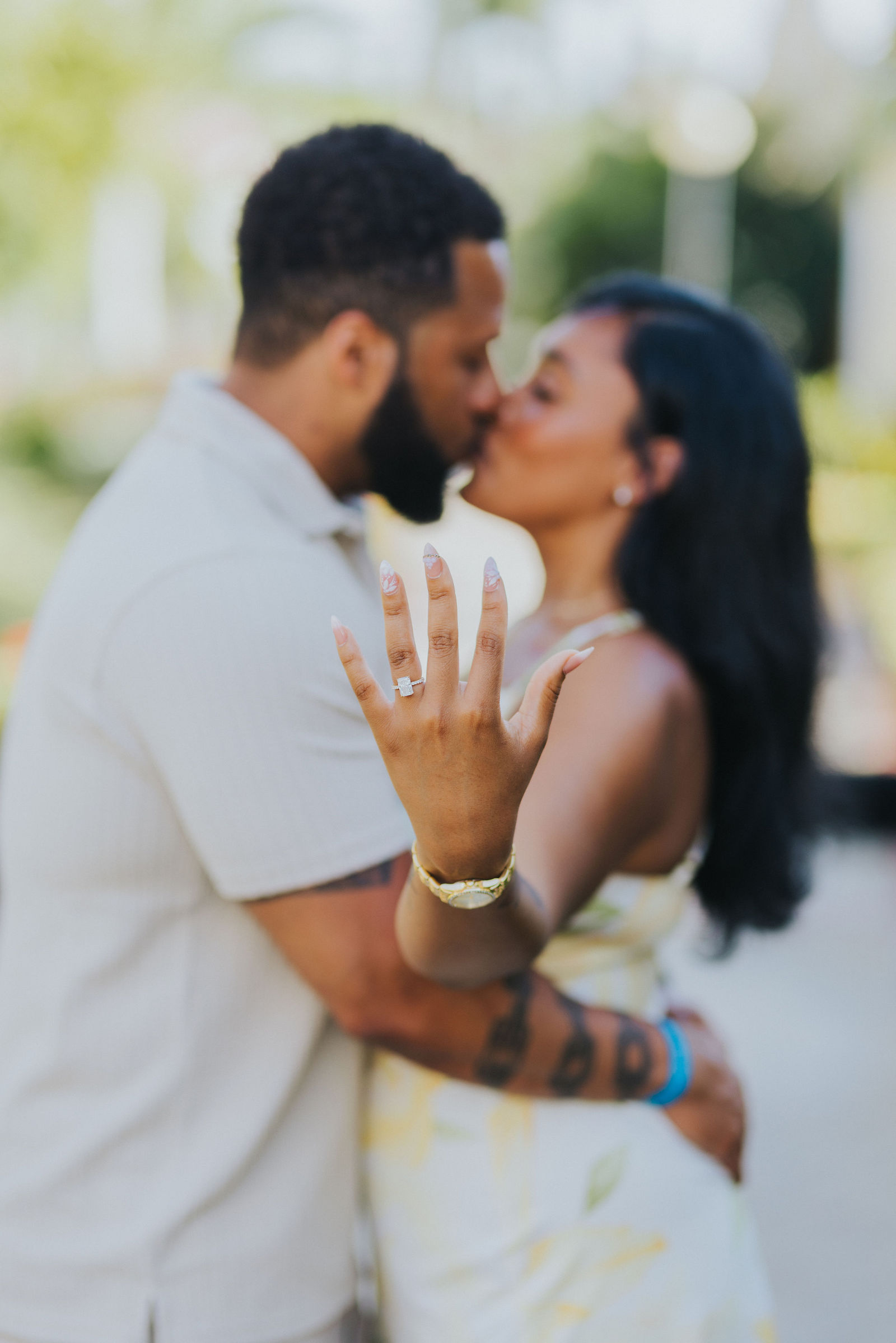 The couple kissing with the ring on her finger