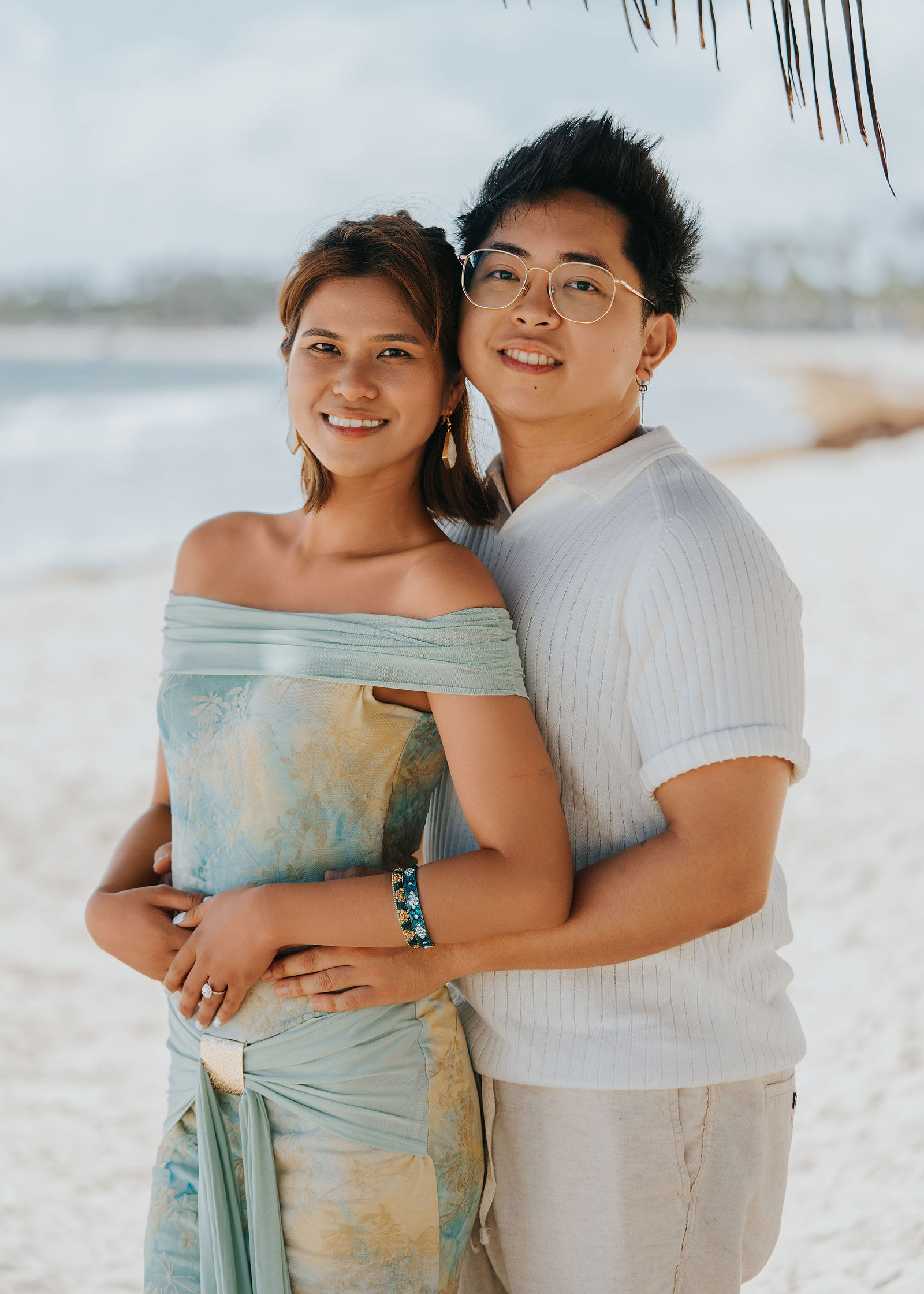 Portrait of the newly engaged couple facing the sea
