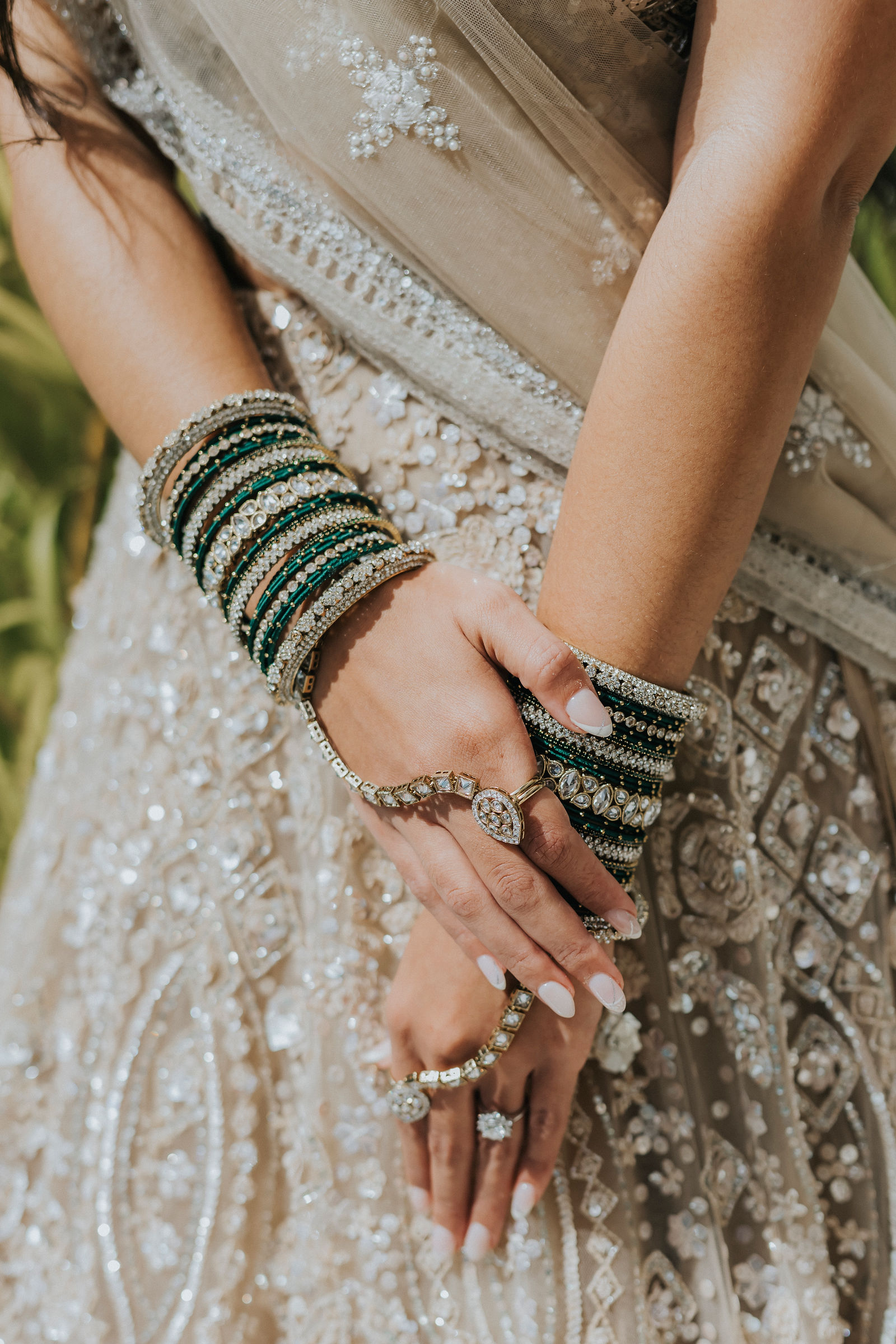 Detail of green bangles and rings on the Indian bride's hands