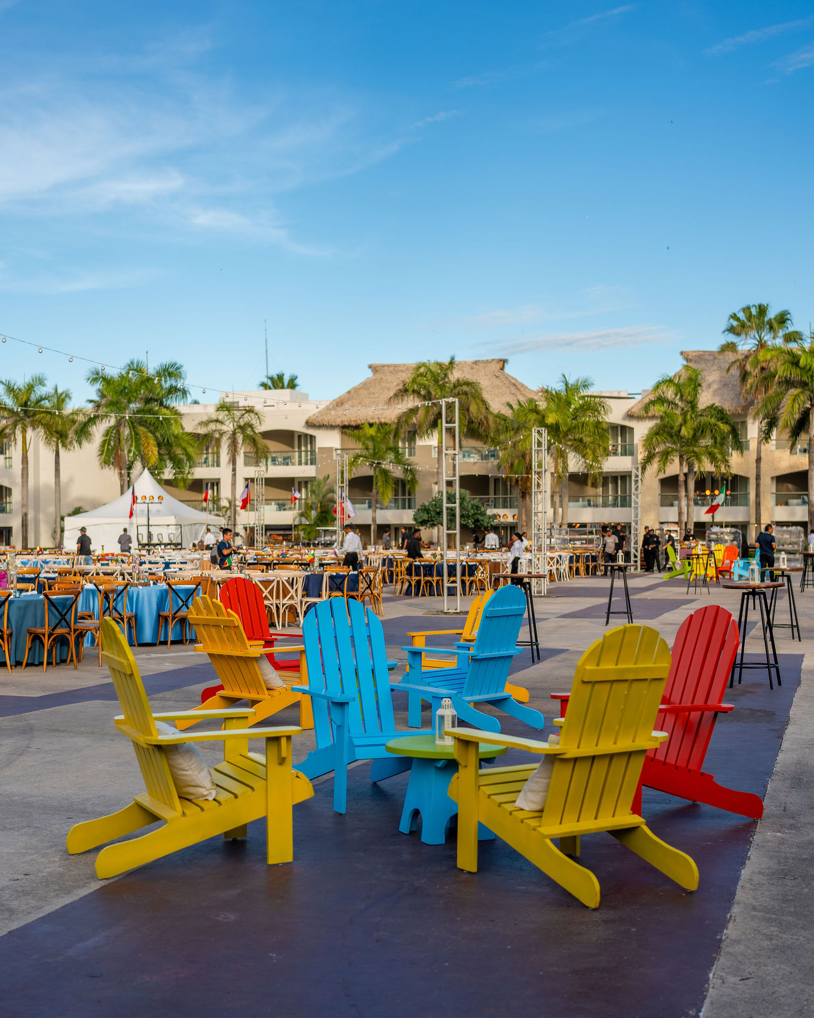 Colourful lounge chairs set up beside the resort pool for the party