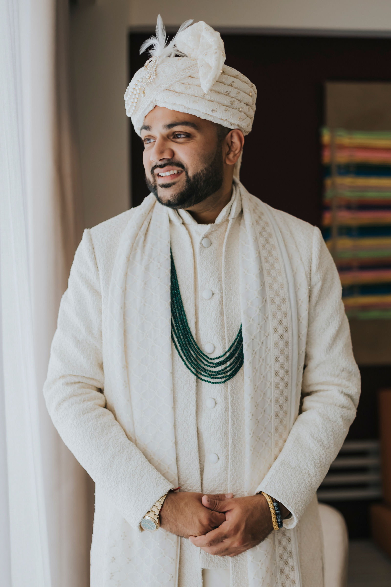 Groom in an ivory sherwani and safa turban before the ceremony