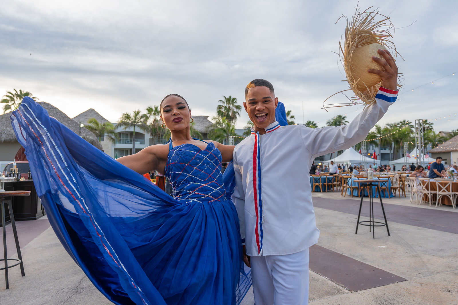 Merengue dancers in a flowing blue gown performing for guests