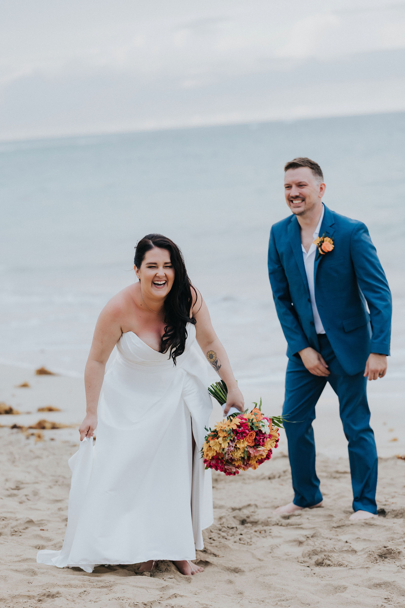 Bride laughing with the groom during beach portraits