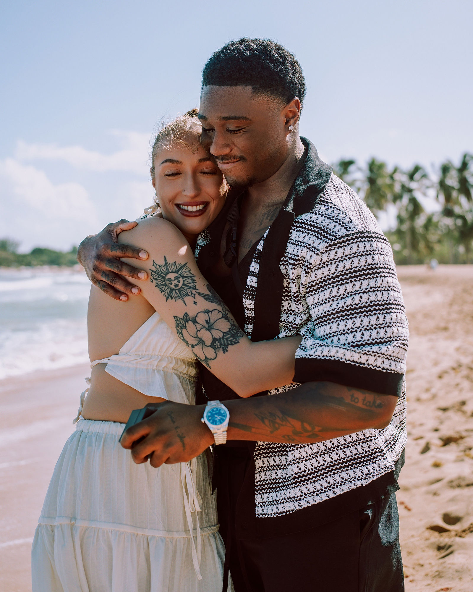 The couple embracing after the yes