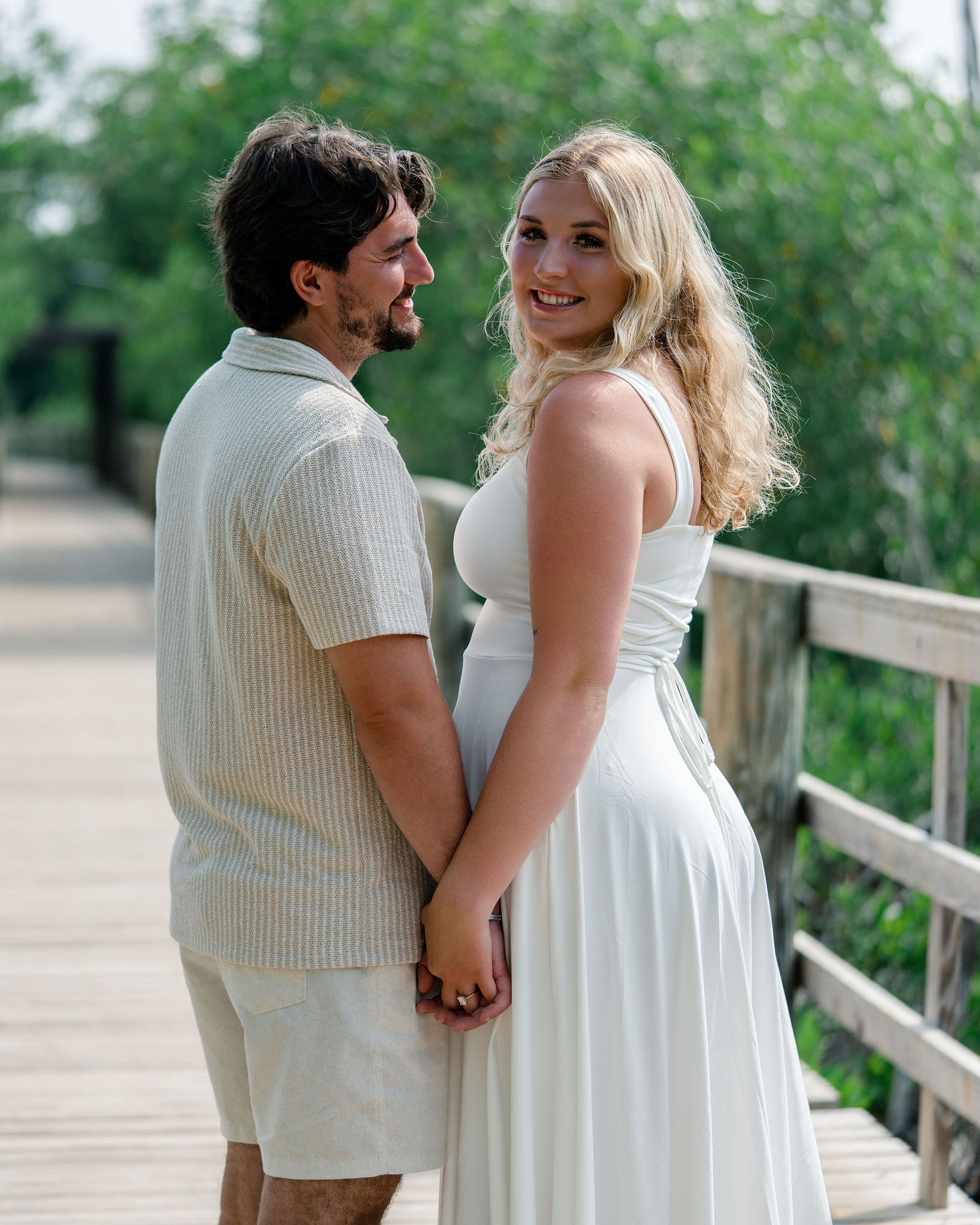 Jessica laughing while held close by Greg among the mangroves