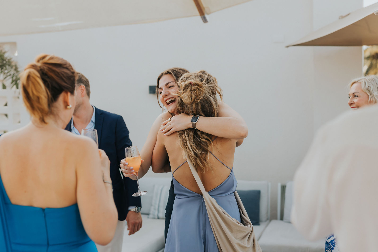Candid embrace between friends during the cocktail hour