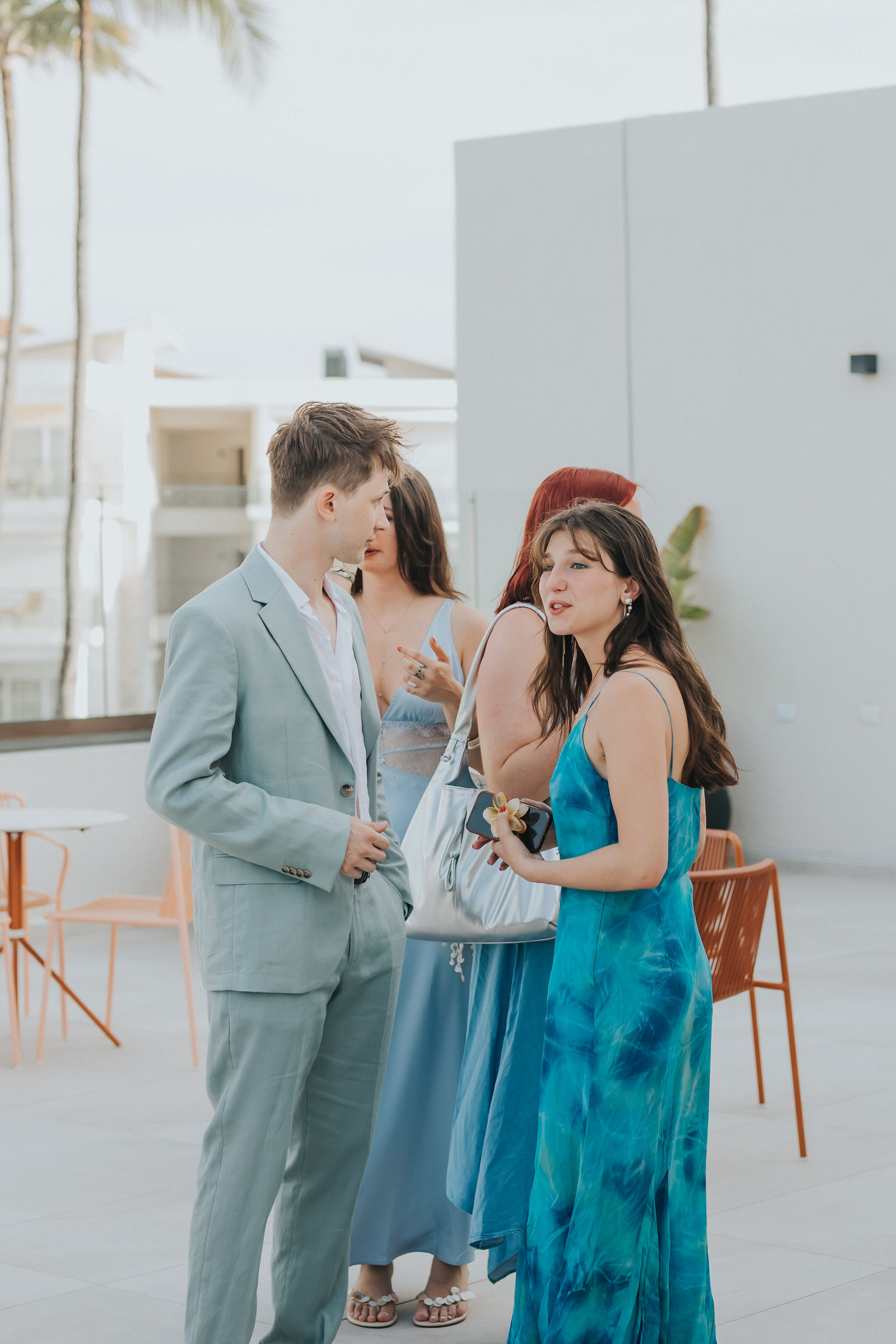 The couple embracing as guests arrive at the welcome dinner