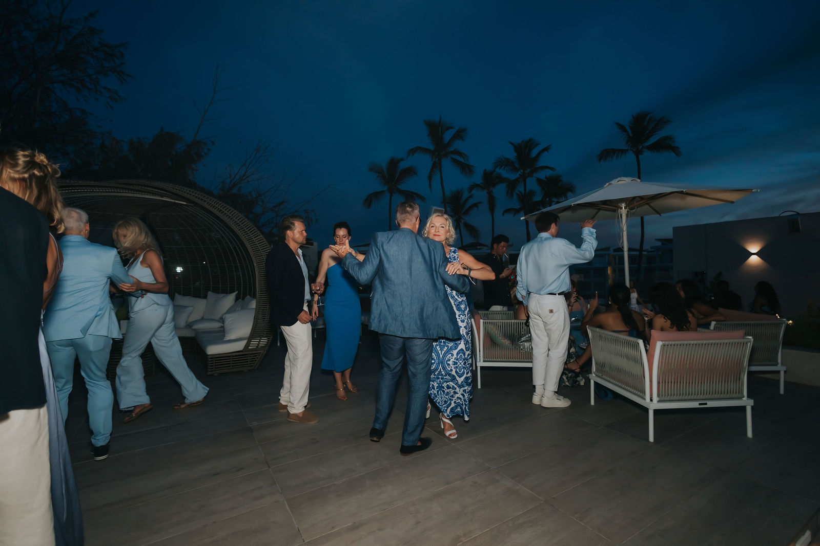 Guests mingling on the terrace after dark
