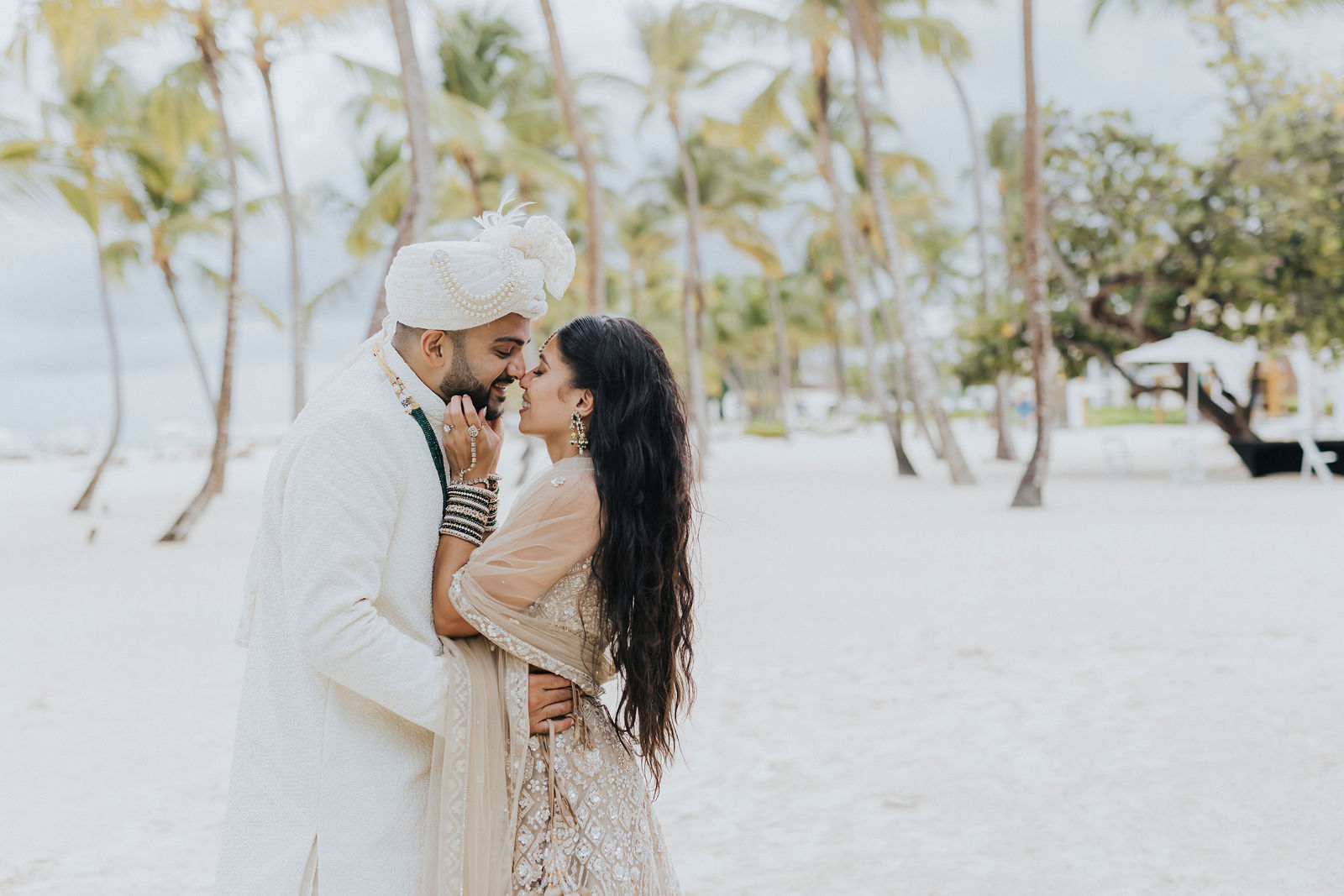 Couple kissing on the Punta Cana shoreline at the end of the wedding day