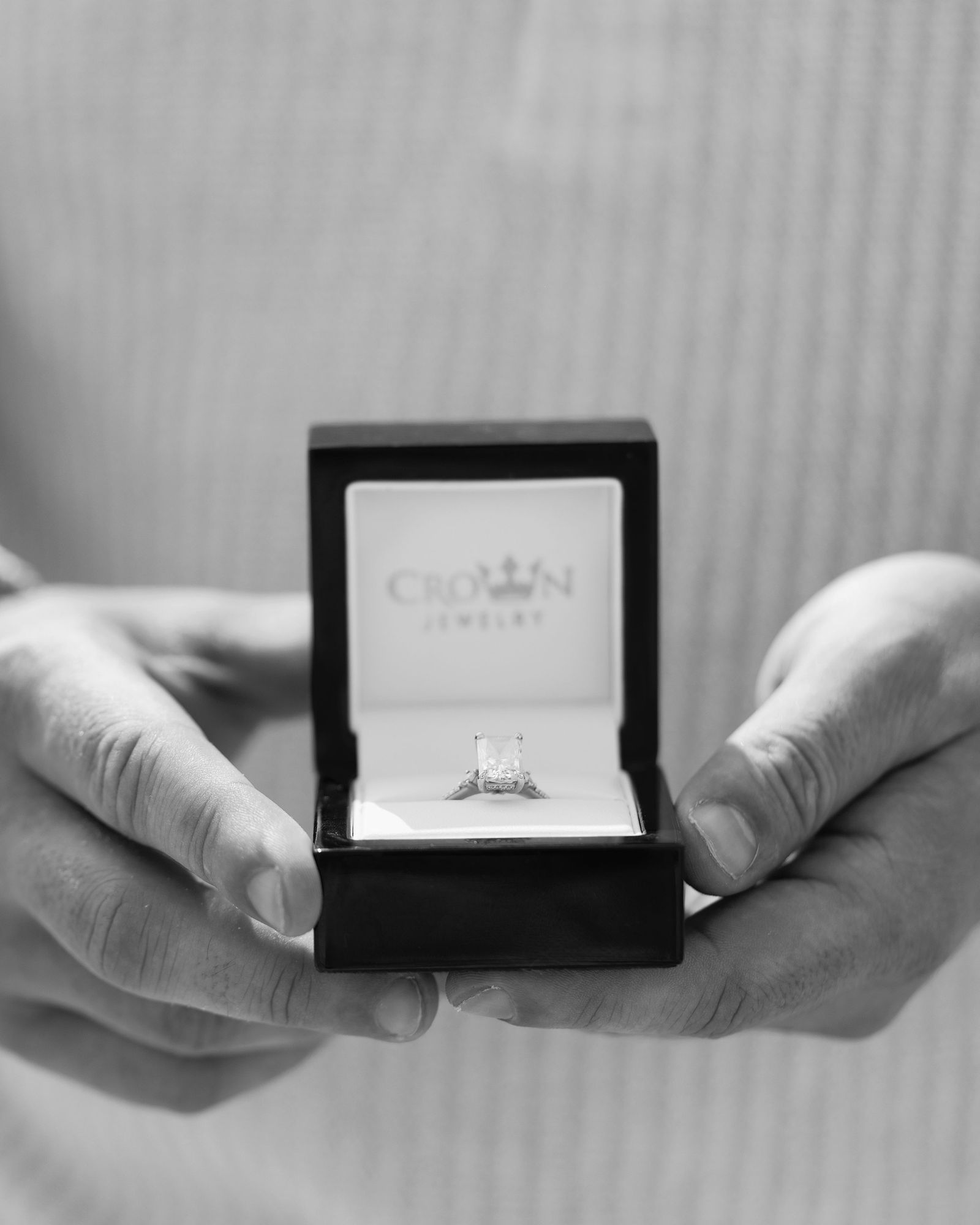 Black and white close-up of the engagement ring in its box